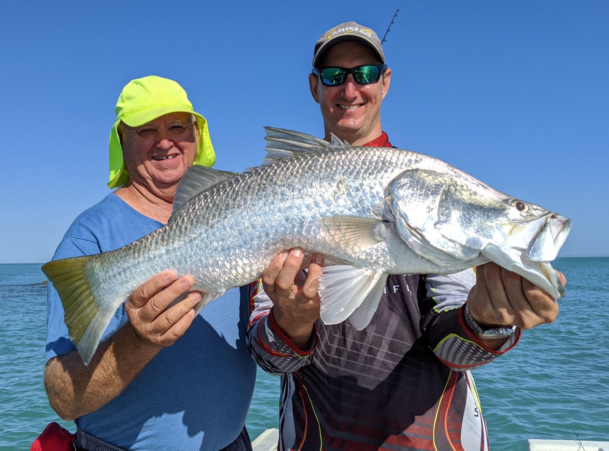 fishermen with their barramundi catch