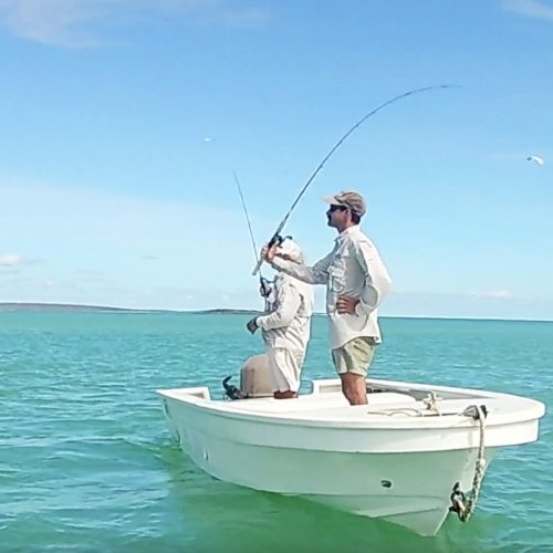 casting a fishing line from a small boat